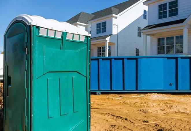 a portable toilet lineup at an active construction site